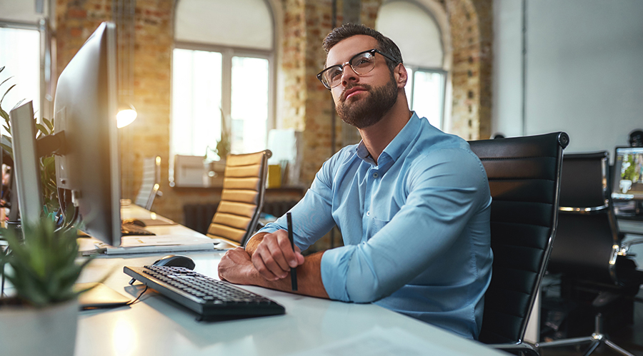 man thinking at laptop