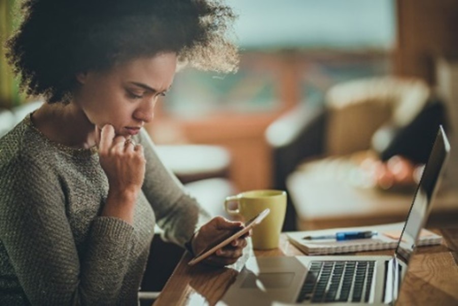 woman thinking looking at phone