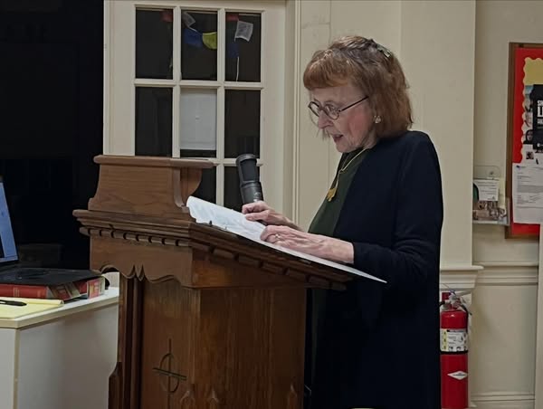 Older Female Pastor at Podium